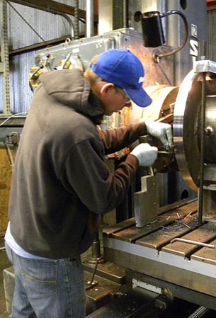 Technician performing water pump repair services