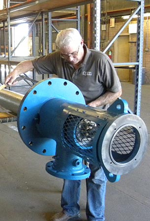 Worker performing industrial pump maintenance at Industrial Pump Manufacturing